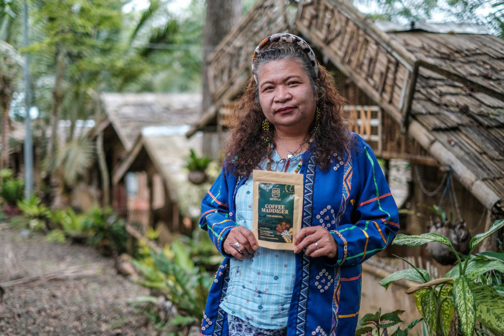 Bai Baby Jerlina Owok of the Bagobo Tagabawa Tribe holds up a pack of “Kape Madigger” produced by the Binaton Bagobo Tagabawa Farmers Livelihood Association in Sitio Rano, Barangay Binaton, Digos City. Photo by Roy Lagarde / Oxfam Pilipinas