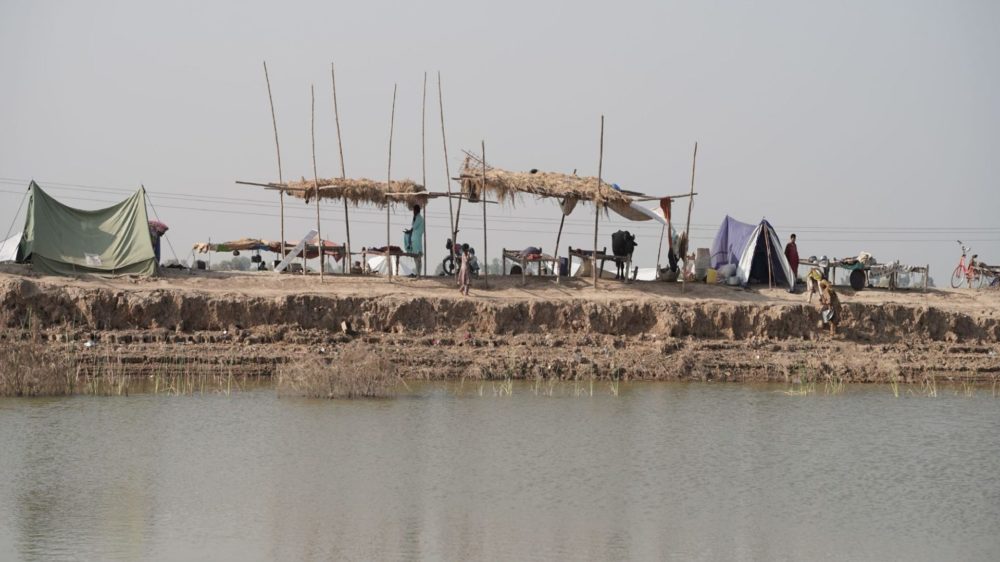 Wide shot of a temporary shelter in Pakistan where a recent flood had just occurred.