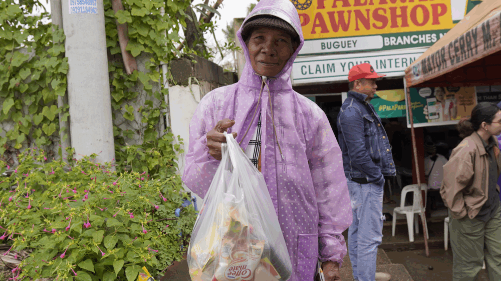 An elderly Indigenous woman purchases food ahead of Cyclone Trami’s landfall in the Philippines. Credit: Humanity & Inclusion